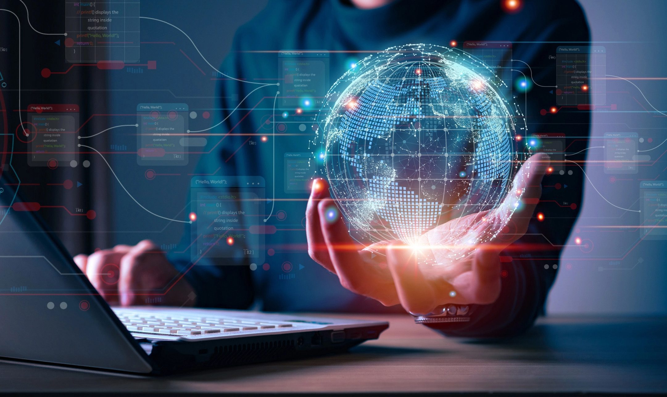 Digital composite image of a person using a laptop with a glowing hologram of a digital globe in their hand, symbolizing global connectivity and cybersecurity